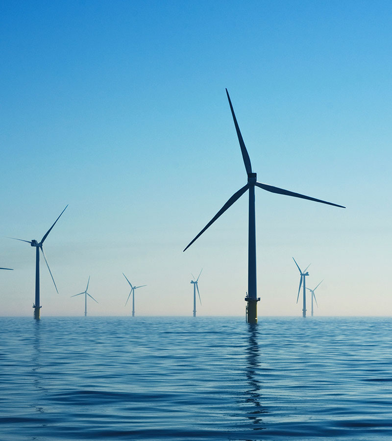 Offshore wind turbines generating clean renewable energy over the ocean
